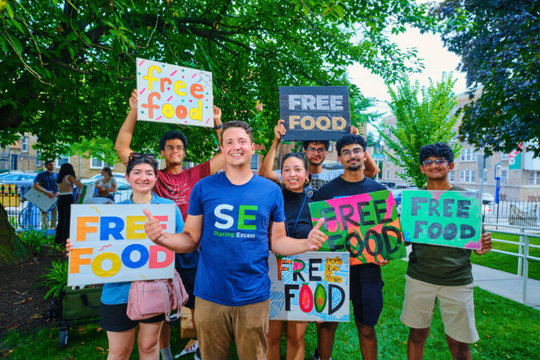 people holding signs for free food